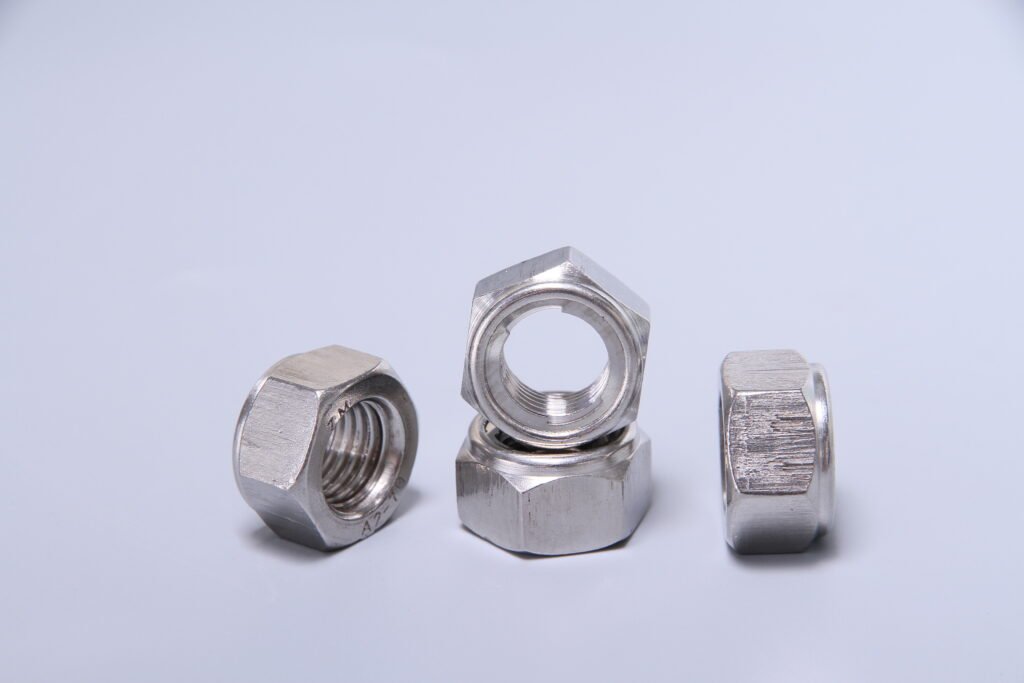 Three metallic hexagonal nuts stacked