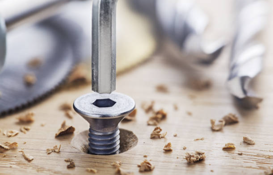 Close-up of a screw and tools
